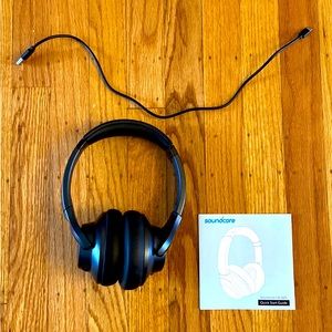 Soundcore noise canceling headphones with charging cord and bag